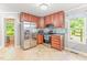 Well-lit kitchen featuring stainless steel appliances, tile backsplash, and ample cabinet space at 2555 Winding Creek Ln, Franklinton, NC 27525