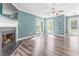 Bright living room boasts a cozy fireplace, ceiling fan, fresh paint and sleek floors at 2555 Winding Creek Ln, Franklinton, NC 27525