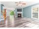Bright living room boasts a cozy fireplace, ceiling fan, fresh paint and sleek floors at 2555 Winding Creek Ln, Franklinton, NC 27525
