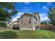 Back exterior featuring a home with horizontal siding and a spacious, green lawn at 2605 Bloomsberry Ridge Dr, Fuquay Varina, NC 27526