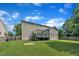 Back exterior featuring a home with horizontal siding, deck, green lawn and mature trees at 2605 Bloomsberry Ridge Dr, Fuquay Varina, NC 27526