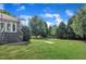 Lush backyard with a spacious lawn, landscaping, and a large deck at 2605 Bloomsberry Ridge Dr, Fuquay Varina, NC 27526