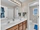 Bathroom featuring double sinks, wood cabinets, and a separate toilet room at 2605 Bloomsberry Ridge Dr, Fuquay Varina, NC 27526
