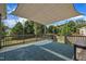 Outdoor deck covered with a modern shade, a stylish outdoor rug and patio string lights at 2605 Bloomsberry Ridge Dr, Fuquay Varina, NC 27526
