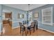Cozy dining room with blue walls, wood floors, and a window for natural light at 2605 Bloomsberry Ridge Dr, Fuquay Varina, NC 27526