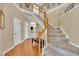 Inviting entryway with hardwood floors, staircase with wood banister, and soaring ceilings at 2605 Bloomsberry Ridge Dr, Fuquay Varina, NC 27526