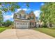 Beautiful two-story home with a well-maintained lawn and a spacious driveway leading to a two-car garage at 2605 Bloomsberry Ridge Dr, Fuquay Varina, NC 27526