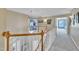 Upstairs hallway with views of other rooms, a wooden railing and neutral paint at 2605 Bloomsberry Ridge Dr, Fuquay Varina, NC 27526
