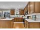 Spacious kitchen featuring wooden cabinetry, a center island, and stainless steel appliances at 2605 Bloomsberry Ridge Dr, Fuquay Varina, NC 27526