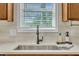 Close-up of a kitchen sink with stainless steel faucet, countertop, and bright natural light at 2605 Bloomsberry Ridge Dr, Fuquay Varina, NC 27526