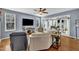 Cozy living room with hardwood floors, comfortable seating, and a view to the sunroom at 2605 Bloomsberry Ridge Dr, Fuquay Varina, NC 27526