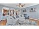 Open-concept living room with hardwood floors, comfortable seating, and arched doorways at 2605 Bloomsberry Ridge Dr, Fuquay Varina, NC 27526