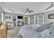 Main bedroom featuring walk-in closet, ensuite bathroom, ceiling fan, and neutral gray paint at 2605 Bloomsberry Ridge Dr, Fuquay Varina, NC 27526