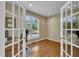 Bright home office with hardwood floors, large arched window, and French doors at 2605 Bloomsberry Ridge Dr, Fuquay Varina, NC 27526