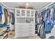 Bright walk-in closet with custom shelving, built-in drawers, and ample storage for clothing and accessories at 2605 Bloomsberry Ridge Dr, Fuquay Varina, NC 27526