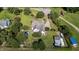 Aerial view showcasing the home's layout, pool, large yard, and surrounding greenery at 2813 Greenridge View Ln, Zebulon, NC 27597