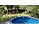 Backyard features an above ground pool and playset for outdoor fun at 2813 Greenridge View Ln, Zebulon, NC 27597