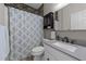 Clean bathroom featuring a stone accent wall and dark vanity with a drop-in sink at 2813 Greenridge View Ln, Zebulon, NC 27597