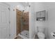 Clean bathroom with a glass door shower, tiled accents, and tiled floors at 2813 Greenridge View Ln, Zebulon, NC 27597