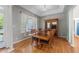 Traditional dining room featuring a wooden table with chairs, display cabinet, and natural light at 2813 Greenridge View Ln, Zebulon, NC 27597