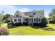 Inviting home features well-kept lawn, manicured shrubs, and classic architectural details at 2813 Greenridge View Ln, Zebulon, NC 27597
