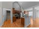 Open-concept kitchen featuring wooden cabinets, granite countertops, and stainless steel appliances at 2813 Greenridge View Ln, Zebulon, NC 27597