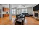 Cozy living room features a stone fireplace, hardwood floors, and comfortable leather seating at 2813 Greenridge View Ln, Zebulon, NC 27597