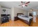 Spacious main bedroom with a tray ceiling, wood floors, and a desk area at 2813 Greenridge View Ln, Zebulon, NC 27597