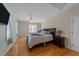 Serene bedroom boasts hardwood floors, ceiling fan, ample natural light, and neutral colors at 2813 Greenridge View Ln, Zebulon, NC 27597
