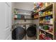 Well-organized pantry featuring shelving for ample storage and a modern washer and dryer at 2813 Greenridge View Ln, Zebulon, NC 27597