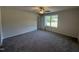 Spacious bedroom with soft carpet, ceiling fan, and natural light from a large window at 299 Starry Sky Dr, Benson, NC 27504