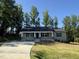 Charming single-story home featuring a welcoming front porch and well-manicured lawn at 299 Starry Sky Dr, Benson, NC 27504