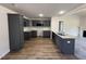 Modern kitchen with gray cabinets, granite countertops, and stainless steel appliances at 299 Starry Sky Dr, Benson, NC 27504