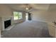 Spacious living room featuring a cozy fireplace, neutral carpet, and ample natural light at 299 Starry Sky Dr, Benson, NC 27504