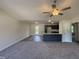 Bright open space showcases a living room, kitchen with a center island, and modern ceiling fan at 299 Starry Sky Dr, Benson, NC 27504