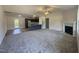 Open-concept living space with a fireplace, modern kitchen, and access to outdoor patio at 299 Starry Sky Dr, Benson, NC 27504