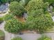 Aerial view of a home surrounded by mature trees in a quiet residential neighborhood at 301 N King Charles Rd, Raleigh, NC 27610