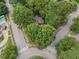 Aerial view showcasing a home with mature trees in a residential neighborhood with sidewalks at 301 N King Charles Rd, Raleigh, NC 27610