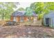 Backyard view showcasing a brick home with a fenced yard, shed, and wood details at 301 N King Charles Rd, Raleigh, NC 27610