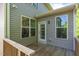 Backyard view of the home's exterior featuring windows, siding, and access to the deck at 304 Garden Walk Dr, Durham, NC 27703