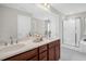Bathroom featuring double sink vanity with quartz counters, wood cabinets, and a glass shower at 304 Garden Walk Dr, Durham, NC 27703