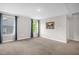 Bedroom featuring large windows with views, neutral walls and carpet, offering a serene space at 304 Garden Walk Dr, Durham, NC 27703