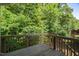 Wooden deck offering views of the dense foliage at 304 Garden Walk Dr, Durham, NC 27703