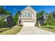 Inviting two-story home with a two-car garage, complemented by lush landscaping and a well-maintained lawn at 304 Garden Walk Dr, Durham, NC 27703