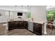 Well-lit kitchen featuring dark wood cabinets, stainless steel appliances, and modern countertops at 304 Garden Walk Dr, Durham, NC 27703