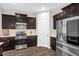 Kitchen featuring stainless steel appliances, dark wood cabinets, and ample counter space at 304 Garden Walk Dr, Durham, NC 27703