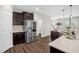 Well-equipped kitchen with stainless steel appliances, dark wood cabinetry, and a stylish countertop, offering ample storage at 304 Garden Walk Dr, Durham, NC 27703