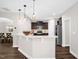Modern kitchen featuring pendant lights, stainless steel appliances, and white countertops with an adjacent dining area at 304 Garden Walk Dr, Durham, NC 27703