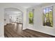 Bright living room featuring dark wood floors and arched doorways to other rooms at 304 Garden Walk Dr, Durham, NC 27703