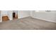 Spacious room with neutral walls and carpet, open view of the upper hallway and an exterior space at 304 Garden Walk Dr, Durham, NC 27703